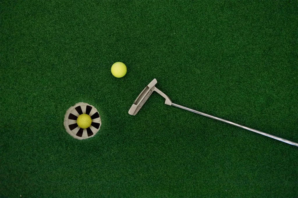 Putting green with golf balls and putter