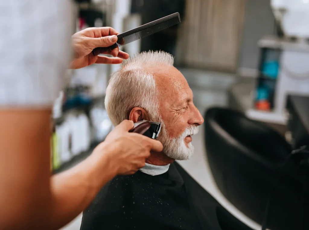 Senior man getting haircut