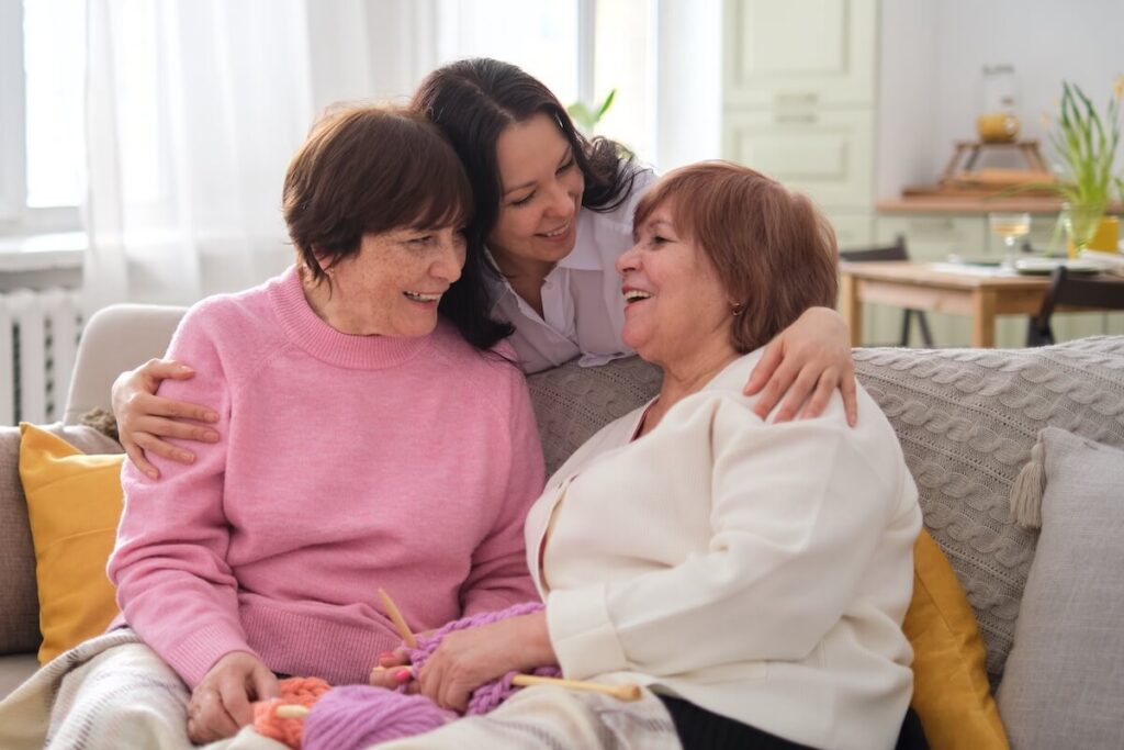 Three Women Bonding Together Laughing Indoors